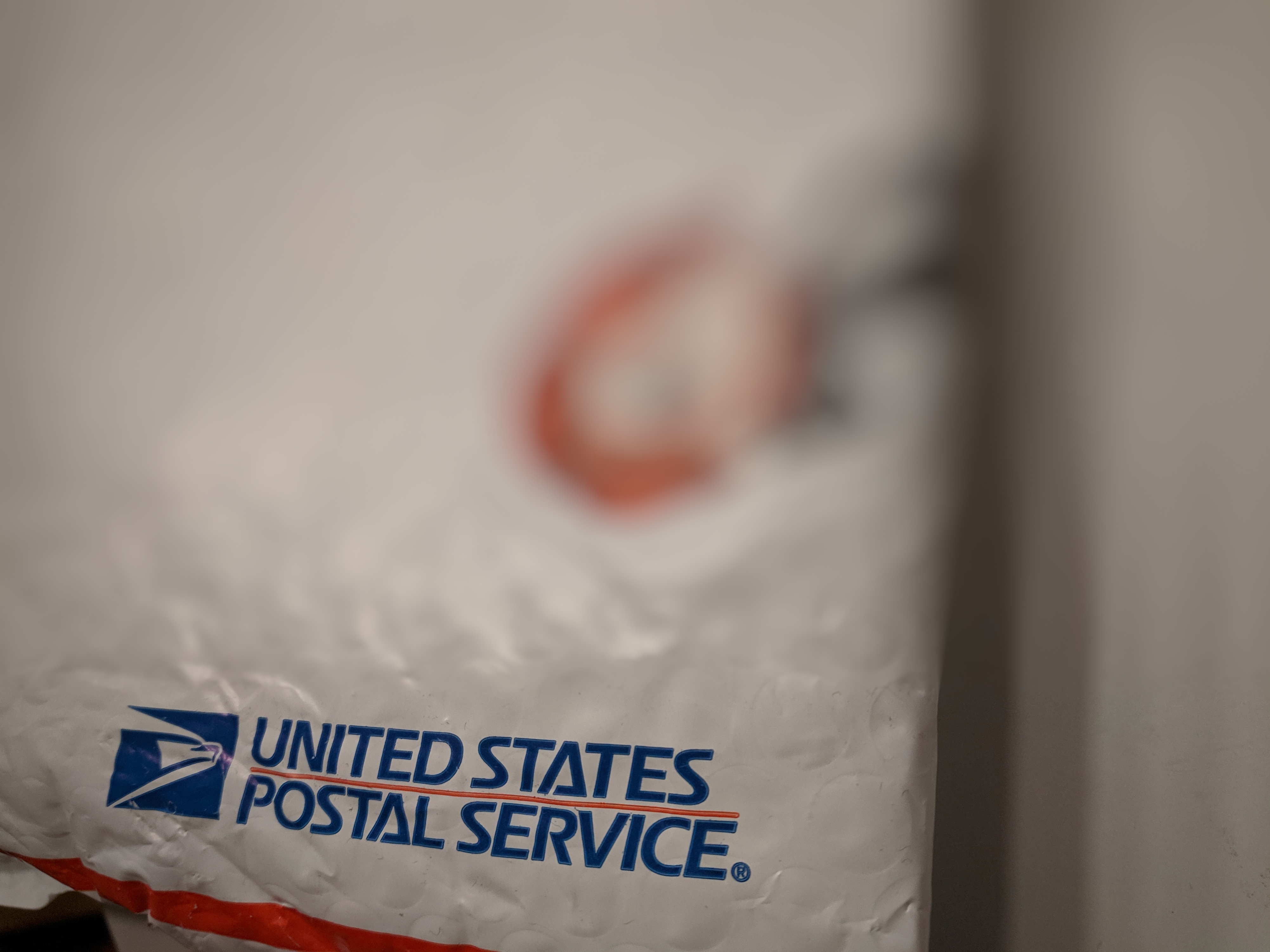 Blurry image of a USPS package