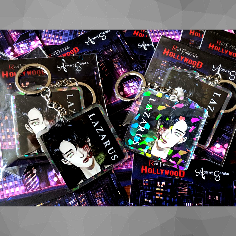 store image of the lazarus 2 inch acrylic keychain. front on left with epoxy coating and on the right is the back with broken mirror holographic layer